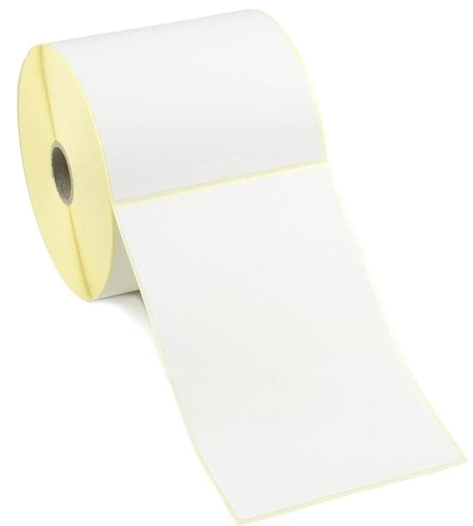 Roll of blank adhesive labels on a yellow core, partially unwound from the roll.